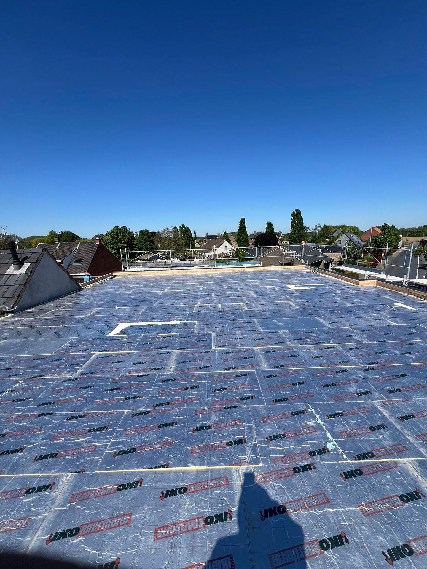 PIR-isolatieplaten over het volledige plat dak tijdens de werken in Wevelgem